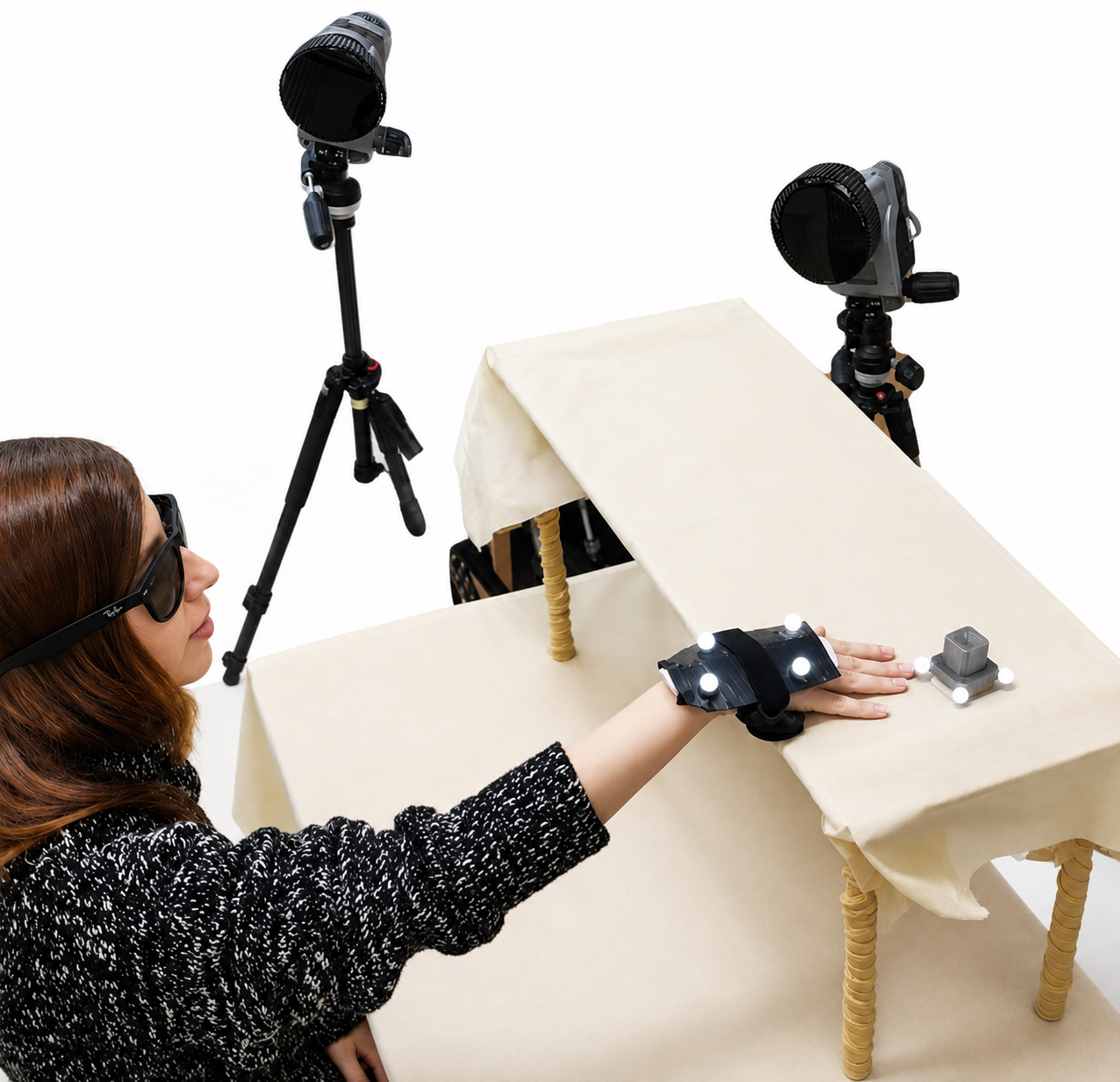 Object localization cueing system setup: motion capture cameras, hand-worn vibration cluster, and 3D-printed target box on a table